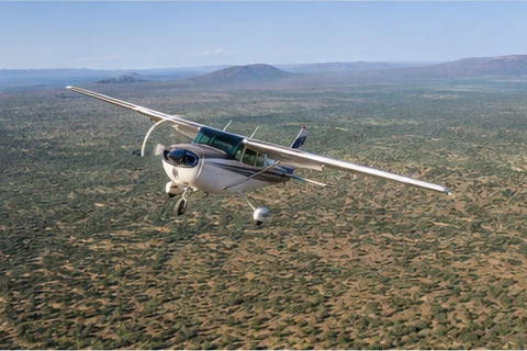 Light aircraft flying above East African savannah