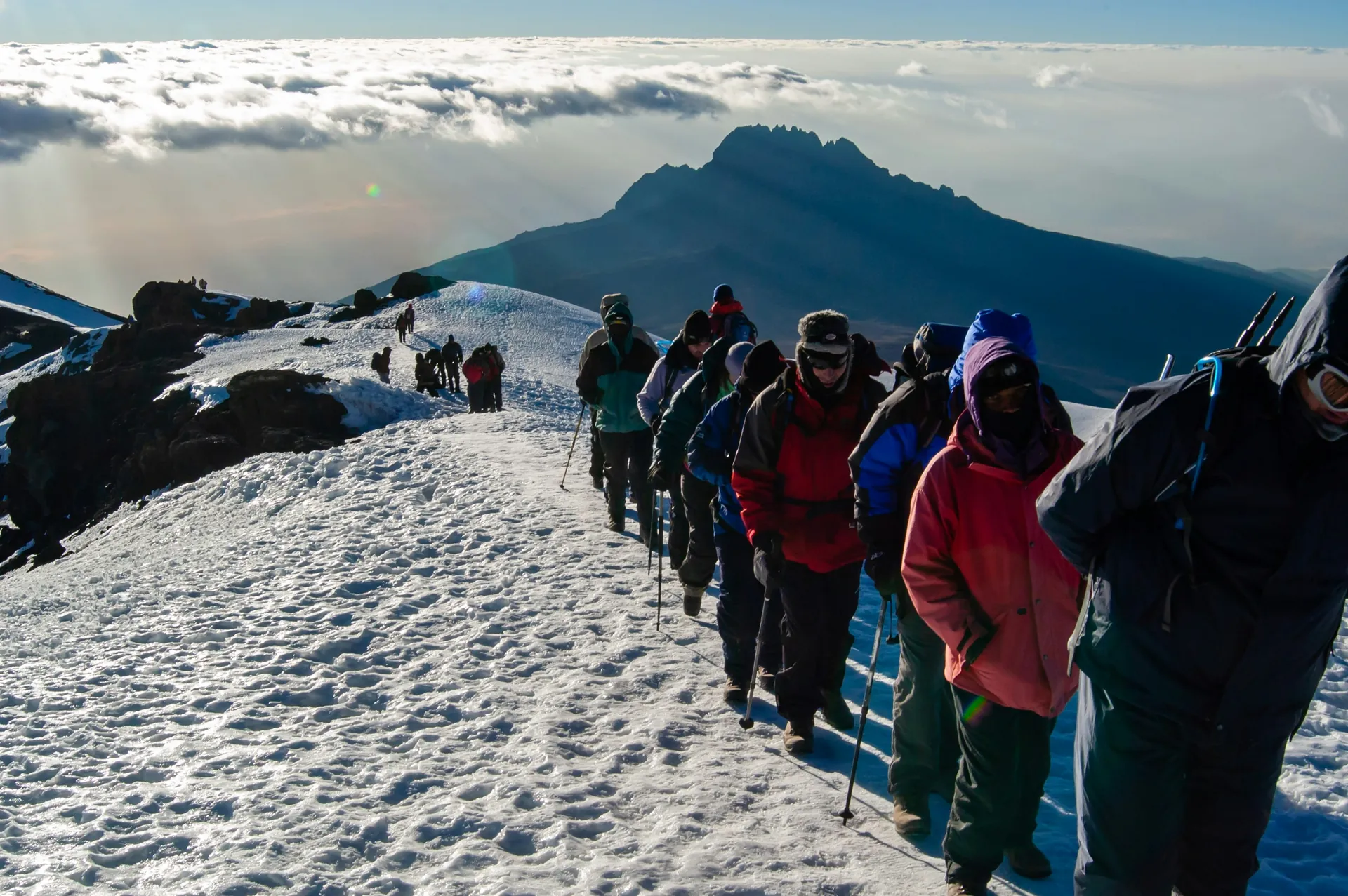 Kilimanjaro trekkers beneath a bright mountain sky